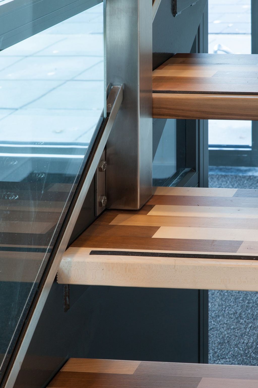 Detail van de glazen balustrade aan de zijkant van de trap.